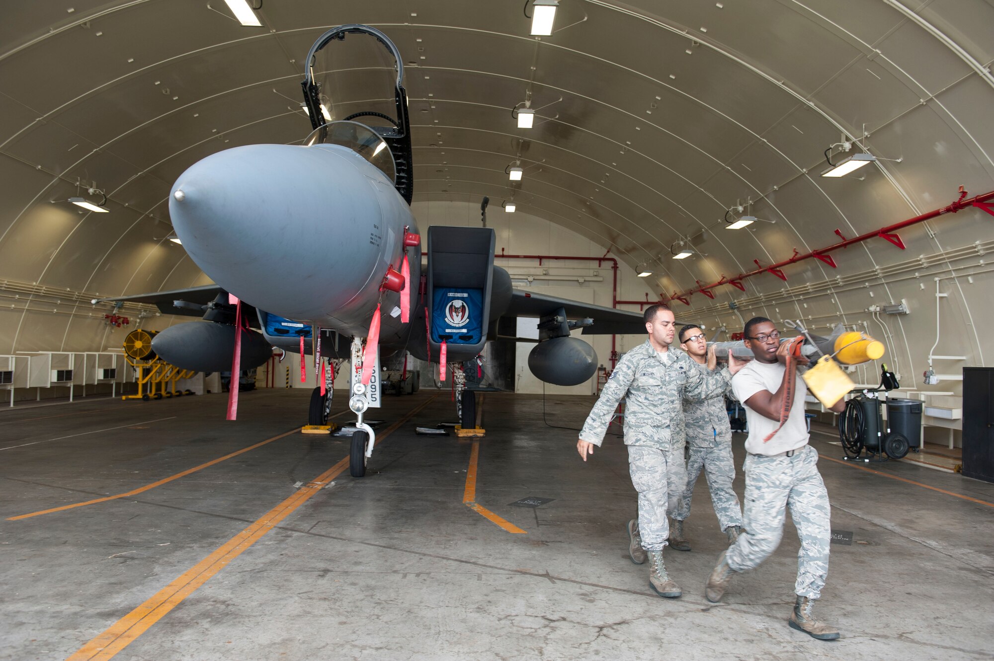 U.S. Air Force Airman 1st Class Kalon Lobbins, Staff Sgt. Nicholas McCants and Senior Airman Jacob Montiel, 44th Aircraft Maintenance Unit load crew members, carry a training model AIM 9X Sidewinder missile Nov. 2, 2016, at Kadena Air Base, Japan. The AIM 9X Sidewinder is an air-to-air, heat-seaking missile used by U.S. Air Force fighter aircraft. (U.S. Air Force photo by Senior Airman Lynette M. Rolen/Released)