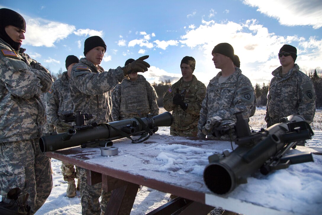 Army Sgt. 1st Class Robert Barrett, second left, briefs paratroopers on safety and how to operate the Carl Gustaf recoilless rifle system at Joint Base Elmendorf-Richardson, Alaska, Nov. 1, 2016. Barrett is assigned to the 25th Infantry Division’s Company B, 3rd Battalion, 509th Parachute Infantry Regiment, 4th Infantry Brigade Combat Team (Airborne), Alaska. Air Force photo by Alejandro Pena