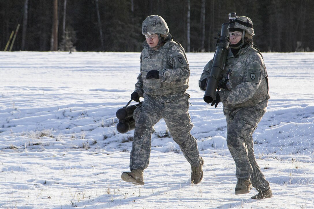 Army Spcs. Anthony Alfaro, left, and Dino Torres rush to a firing position during live-fire training on the Carl Gustaf recoilless rifle system at Joint Base Elmendorf-Richardson, Alaska, Nov. 1, 2016. Alfaro and Torres are assigned to the 25th Infantry Division’s Company B, 3rd Battalion, 509th Parachute Infantry Regiment, 4th Infantry Brigade Combat Team (Airborne), Alaska. Air Force photo by Alejandro Pena