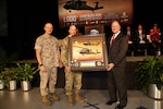 Dan Schultz (right), president of Sikorsky Aircraft, presented a commemorative plaque for the delivery of the 1000th Blackhawk delivery to the Army to Defense Contract Management Agency Sikorsky’s commander, Marine Col. Jack Perrin (far left), and Army Col. William Jackson, Utility Helicopter Program Office program manager, during an Oct. 13 ceremony in Stratford, Connecticut. (Photo courtesy of Stuart Walls and Sikorsky Aircraft)

