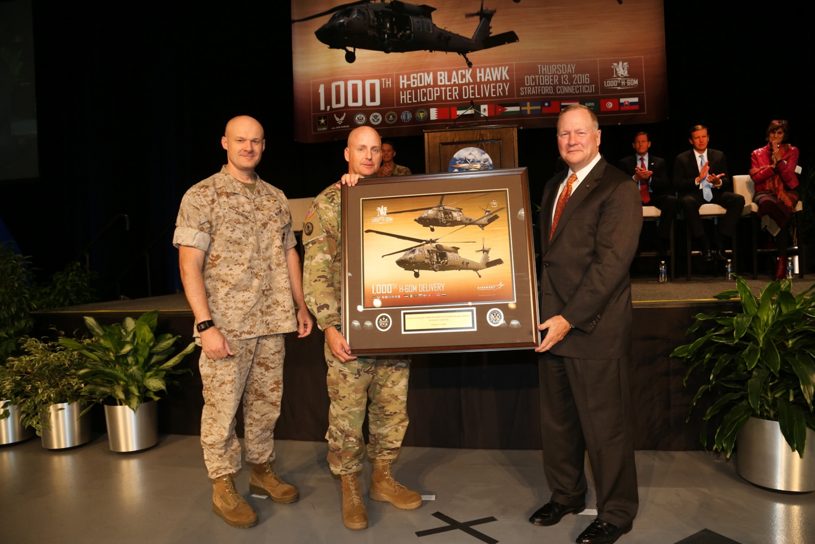 Dan Schultz (right), president of Sikorsky Aircraft, presented a commemorative plaque for the delivery of the 1000th Blackhawk delivery to the Army to Defense Contract Management Agency Sikorsky’s commander, Marine Col. Jack Perrin (far left), and Army Col. William Jackson, Utility Helicopter Program Office program manager, during an Oct. 13 ceremony in Stratford, Connecticut. (Photo courtesy of Stuart Walls and Sikorsky Aircraft)

