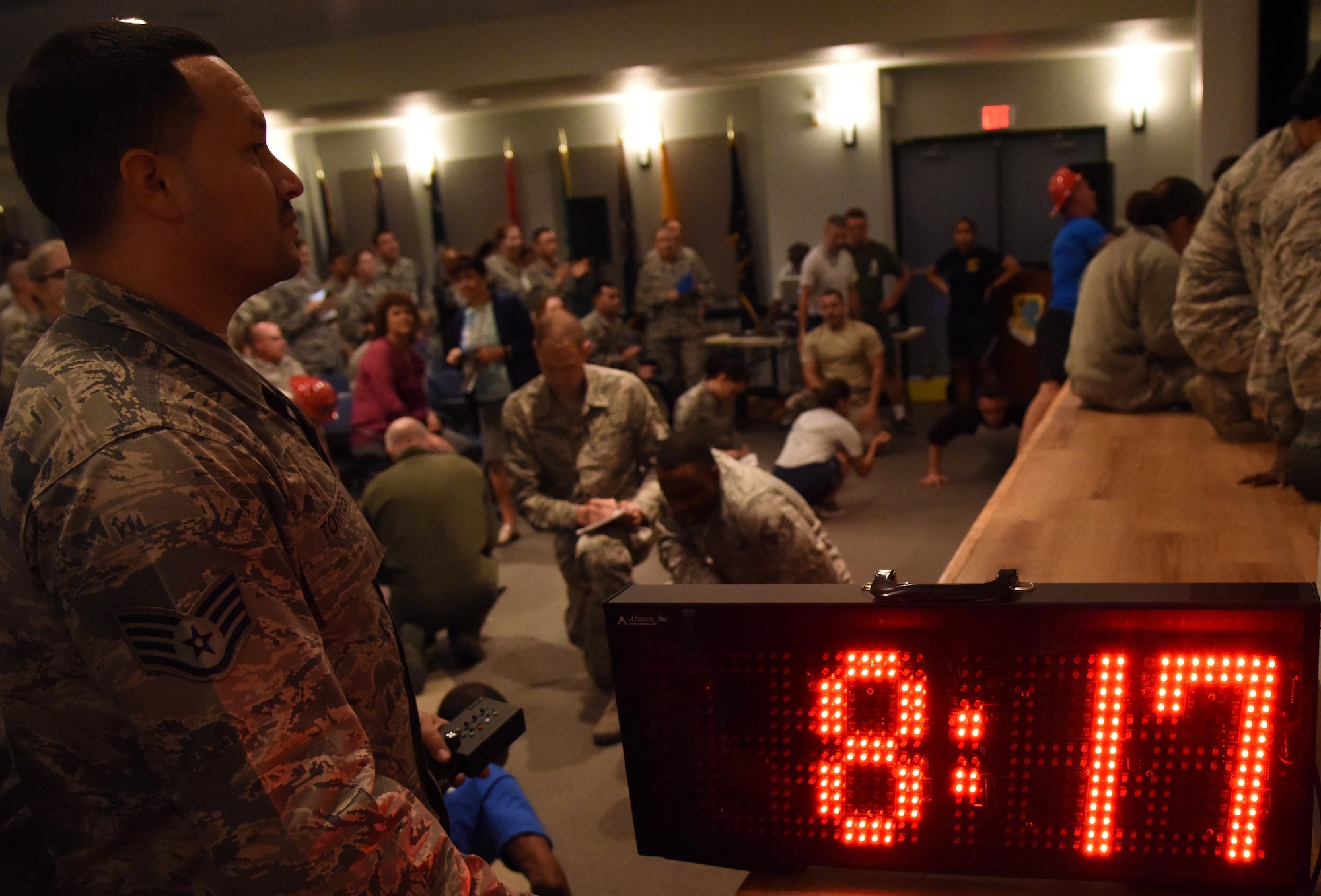 Staff Sgt. Andre Torres, 81st Medical Support Squadron medical equipment management office NCO in charge, controls the countdown clock during the 81st Medical Group Push-up Competition at the Keesler Medical Center Don Wylie Auditorium Nov. 1, 2016, on Keesler Air Force Base, Miss. Seven five-person teams competed in the event pushing out a total of 6,272 push-ups. The 81st Dental Squadron was this year’s winner with 1,127 push-ups. The Airmen who participated in the event raised money to support the Krewe of Medics Mardi Gras Ball. (U.S. Air Force photo by Kemberly Groue/Released)
