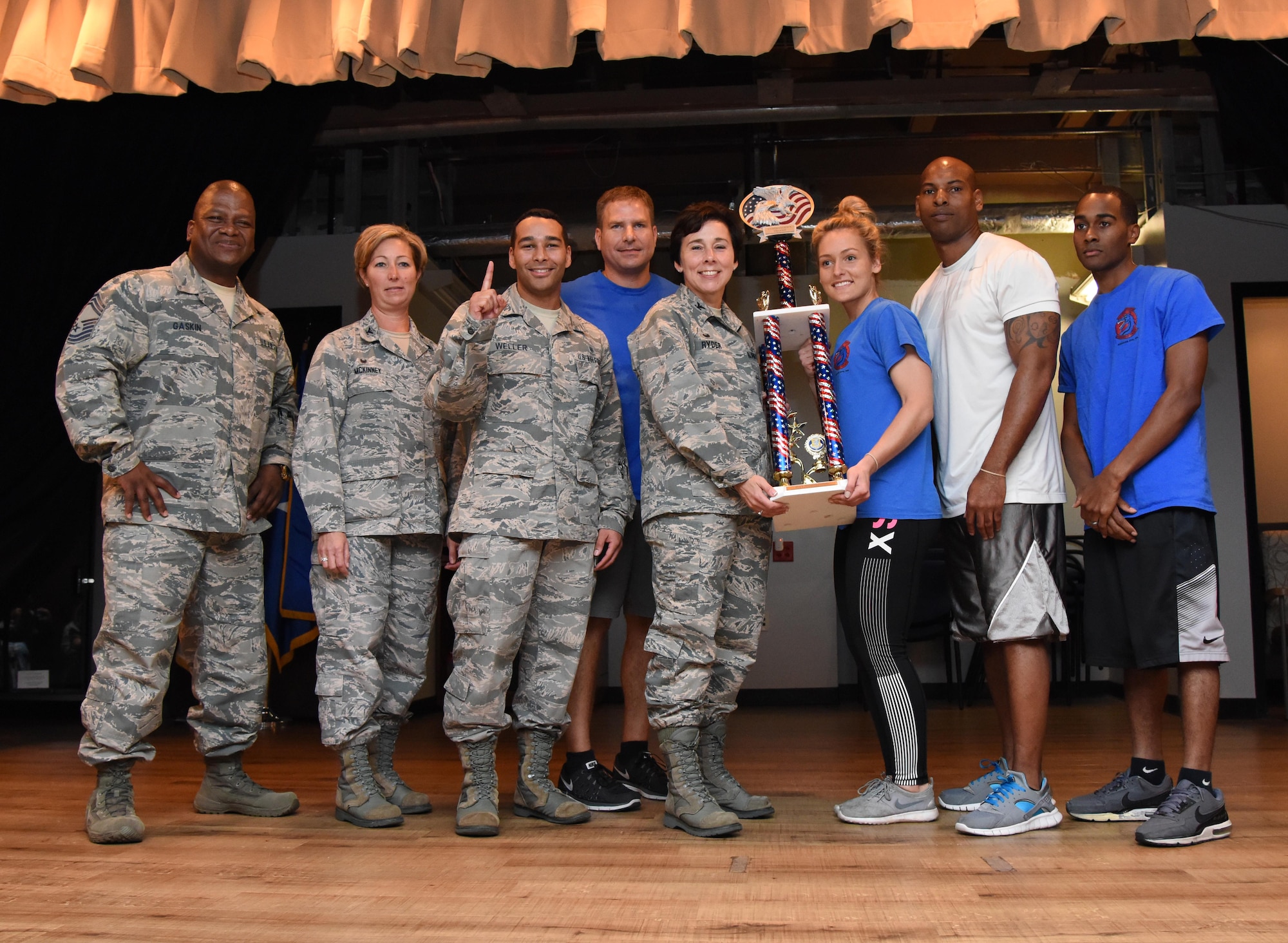 Members of the 81st Dental Squadron are presented the first place trophy by Col. Jeannine Ryder, 81st Medical Group commander, during the 81st MDG Push-up Competition at the Keesler Medical Center Don Wylie Auditorium Nov. 1, 2016, on Keesler Air Force Base, Miss. Seven five-person teams competed in the event pushing out a total of 6,272 push-ups. The 81st Dental Squadron accumulated 1,127 push-ups. The Airmen who participated in the event raised money to support the Krewe of Medics Mardi Gras Ball. (U.S. Air Force photo by Kemberly Groue/Released)
