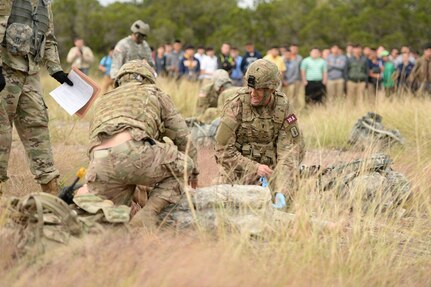 A pair of combat medics treats a simulated patient during the Best Medic Competition at JBSA-Camp Bullis Oct. 25. The 72-hour contest forces medics to perform feats of physical and emotional strength as well as critical thinking in hopes
to being named the Army’s best medics.