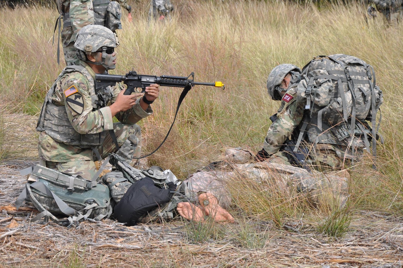 A combat medic provides cover while his partner checks
on a simulated patient during the Best Medic Competition
at JBSA-Camp Bullis Oct. 25.