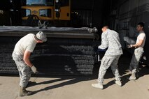 Airmen from the 5th Civil Engineer Squadron pavements and equipment section change bristles on a snow broom at Minot Air Force Base, N.D., Nov. 1, 2016. The 5th Civil Engineer Squadron pavements and equipment section is responsible for snow removal on mission essential routes and sections on base. (U.S. Air Force photo/Senior Airman Kristoffer Kaubisch)