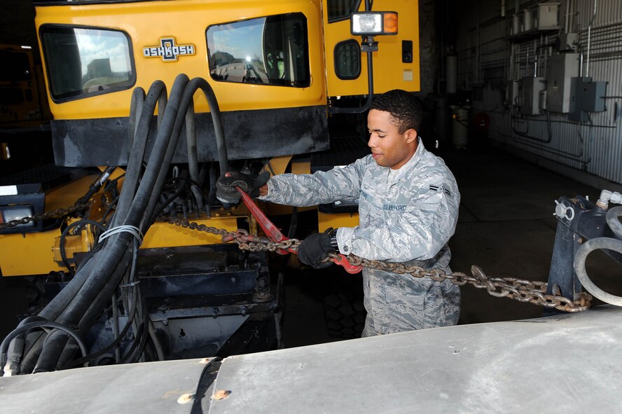 Airman 1st Class Harold McIntyre, 5th Civil Engineer Squadron pavements and equipment apprentice, removes a chain from a snow broom at Minot Air Force Base, N.D., Nov. 1, 2016. From the flight line to the missile fields, snow control is hard at work every day to make sure the mission continues successfully. (U.S. Air Force photo/Senior Airman Kristoffer Kaubisch)