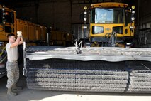 Airman 1st Class Devan Gordan, 5th Civil Engineer Squadron pavements and equipment apprentice, fastens a snow broom to a plow at Minot Air Force Base, N.D., Nov. 1, 2016. The 5th Civil Engineer Squadron pavements and equipment section is responsible for snow removal on mission essential routes and sections on base. (U.S. Air Force photo/Senior Airman Kristoffer Kaubisch)