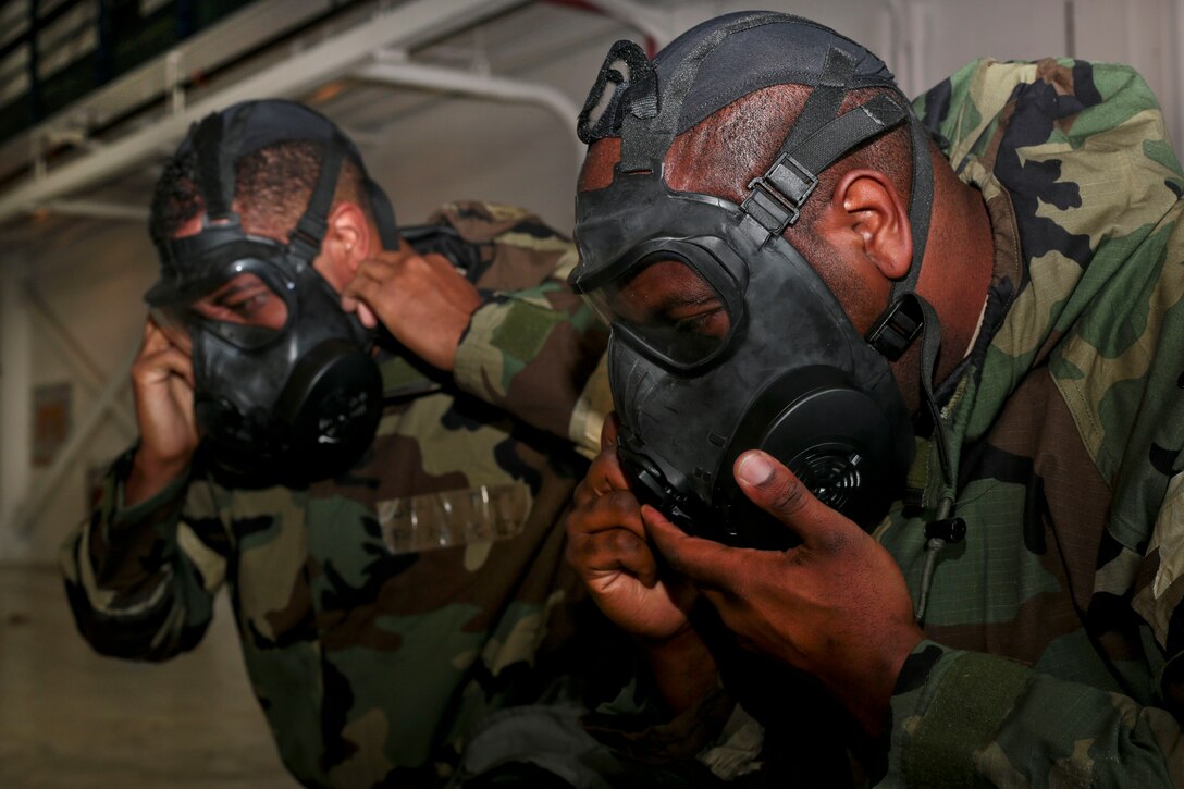 Airmen put on the M50 protective mask during training at Joint Base McGuire-Dix-Lakehurst, N.J., Oct. 30, 2016. Air National Guard photo by Tech. Sgt. Matt Hecht