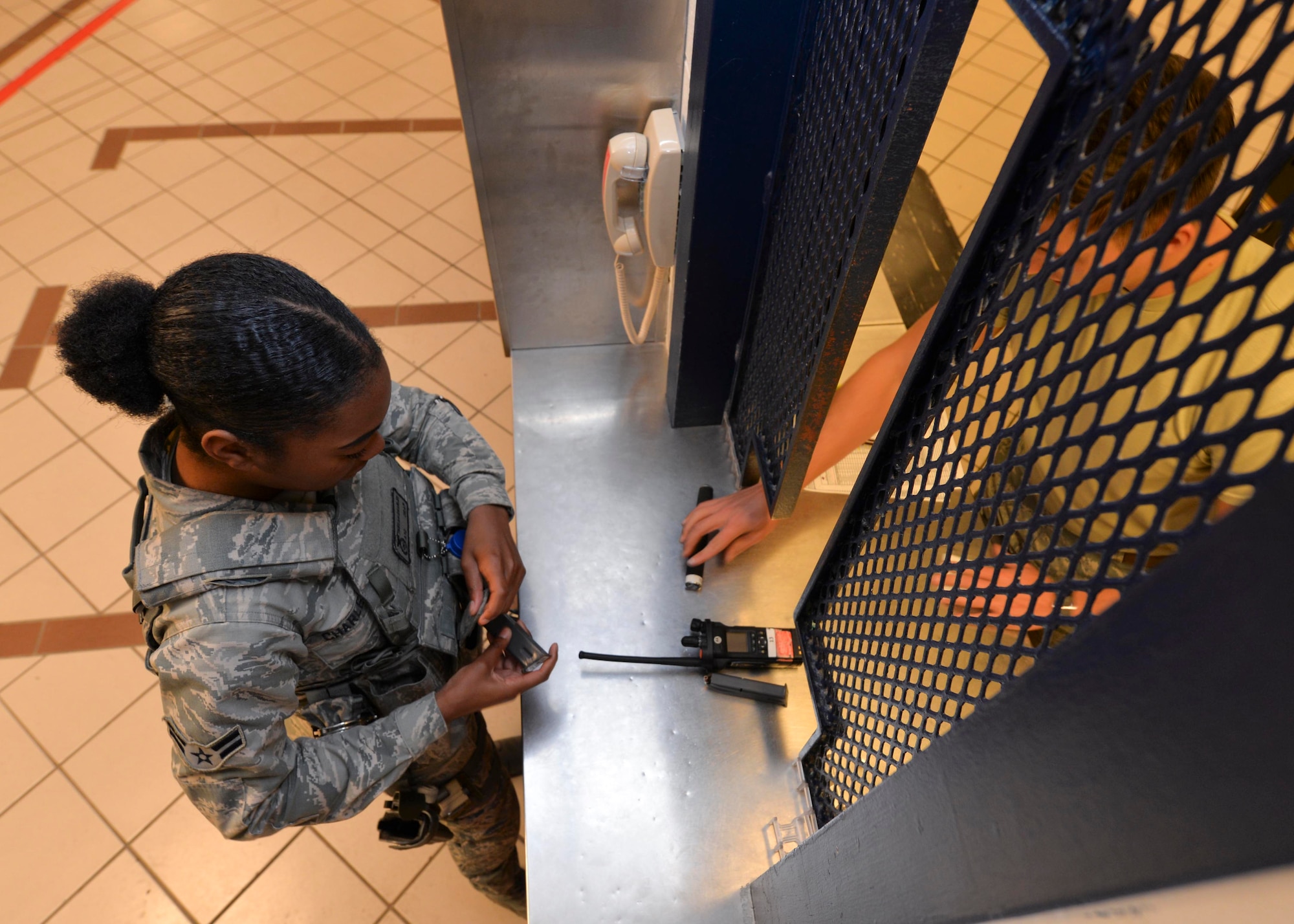 Airman 1st Class John Stumpf, an armorer assigned to the 28th Security Forces Squadron, equips Airman 1st Class Tkeyah Charley, a response force member assigned to the 28th SFS, with equipment at the armory at Ellsworth AFB, S.D., Oct. 25, 2016. Security forces Airmen have multiple levels of force available for daily use including the M4 carbine rifle, M9 pistol, batons and less-than-lethal weapons. (U.S. Air Force photo by Airman 1st Class Donald Knechtel)