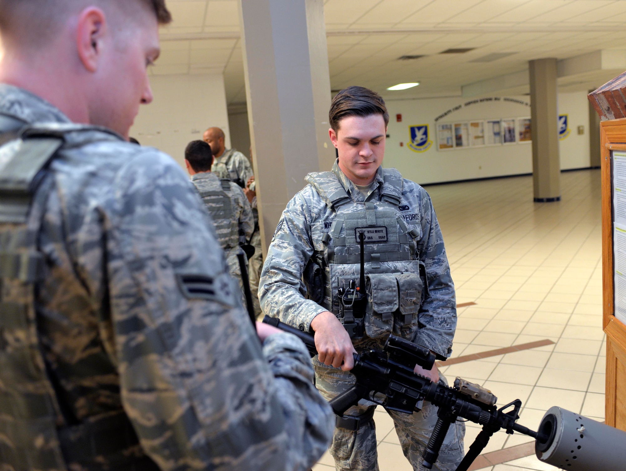 Senior Airman Kyle White, a response force member assigned to the 28th Security Forces Squadron, and Airman 1st Class Anthony Brown, a response force member assigned to the 28th SFS, clear an M4 carbine rifle at Ellsworth AFB, S.D., Oct. 25, 2016. In addition to housing government-owned firearms, the armory can store the firearms of Airman dormitory residents and visitors for safe keeping. (U.S. Air Force photo by Airman 1st Class Donald Knechtel)

