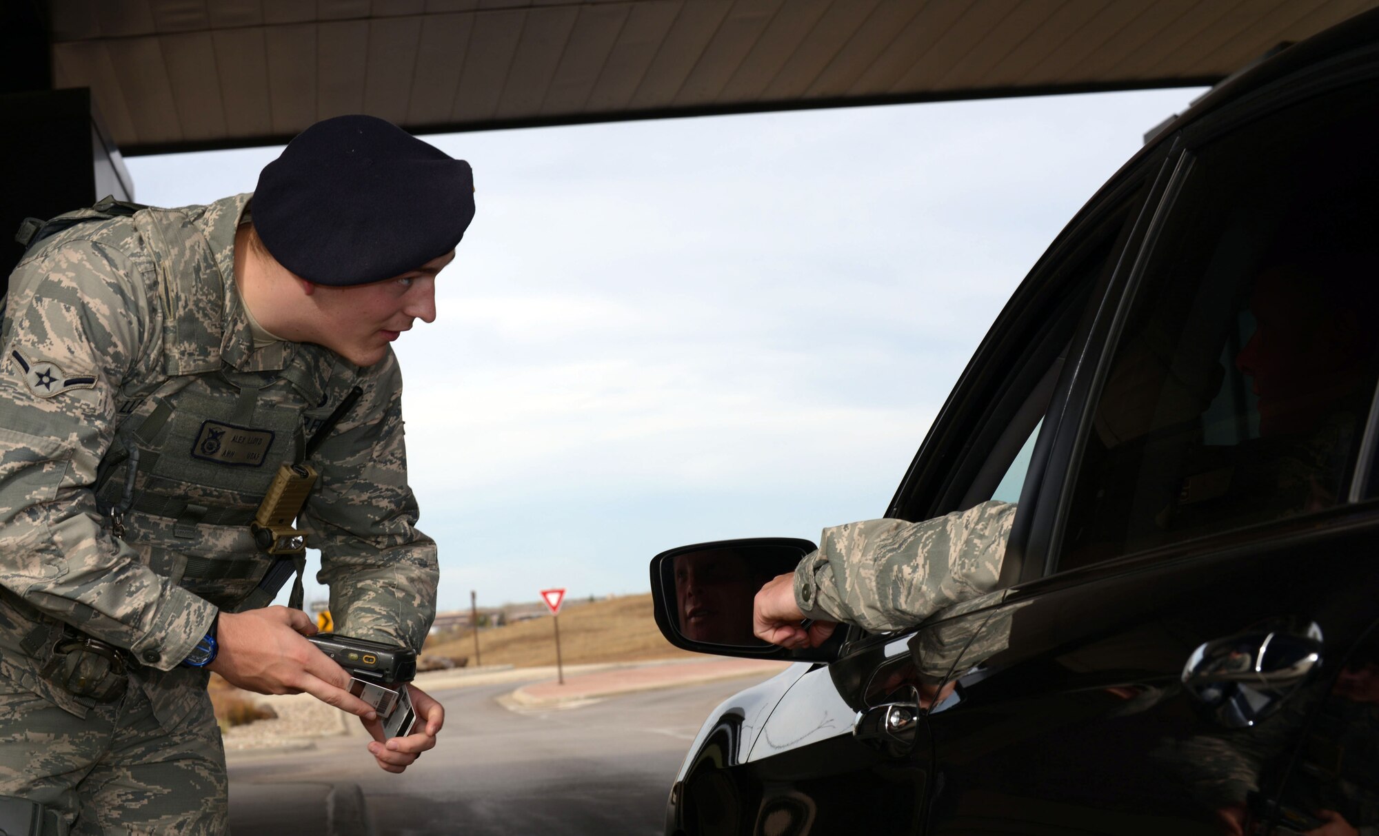 Airman Alex Lloyd, a response force member assigned to the 28th Security Forces Squadron, clears an Airman for entry at the Liberty Gate at Ellsworth AFB, S.D., Oct. 27, 2016. Defenders guard the gate 24 hours a day to ensure the base is secure. (U.S. Air Force photo by Airman 1st Class Donald Knechtel)