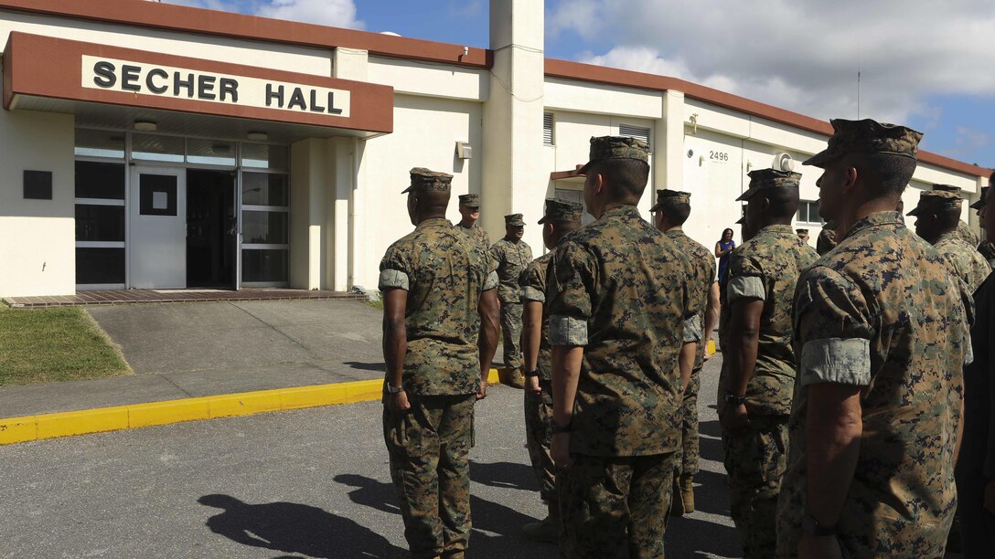 Marines from Okinawa, Japan, stand at attention for a Purple Heart award ceremony in front of Secher Hall on Camp Hansen, Okinawa, Japan, October 28, 2016. The Purple Heart was presented to Lt. Col. Robert C. Sellers, 3rd Marine Expeditionary Brigade Assistant Chief of Staff G-4. The ceremony was held in front of Secher Hall to remind those in attendance to remember the fallen. Sellers is from Belvidere, Illinois.