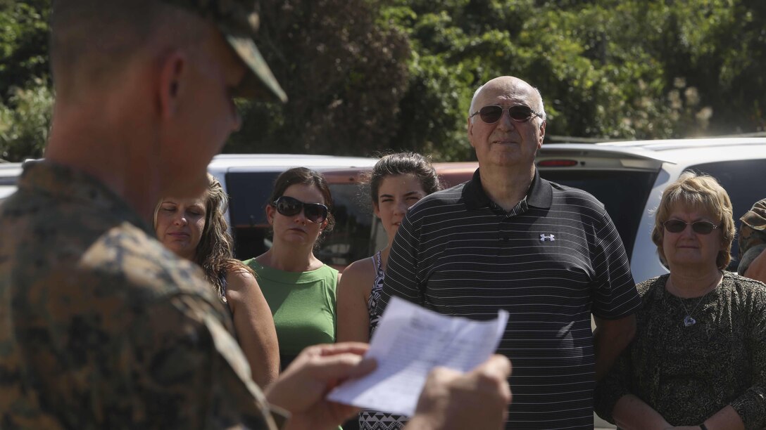 Brig. Gen. John Jansen, 3d Marine Expeditionary Brigade Commanding General, reads a citation during a Purple Heart award ceremony in front of Secher Hall on Camp Hansen, Okinawa, Japan, October 28, 2016. The Purple Heart was presented to Lt. Col. Robert C. Sellers, 3rd Marine Expeditionary Brigade Assistant Chief of Staff G-4. The ceremony was held in front of Secher Hall to remind those in attendance to remember the fallen. Jansen is from Marion, Indiana and Sellers is from Belvidere, Illinois.
