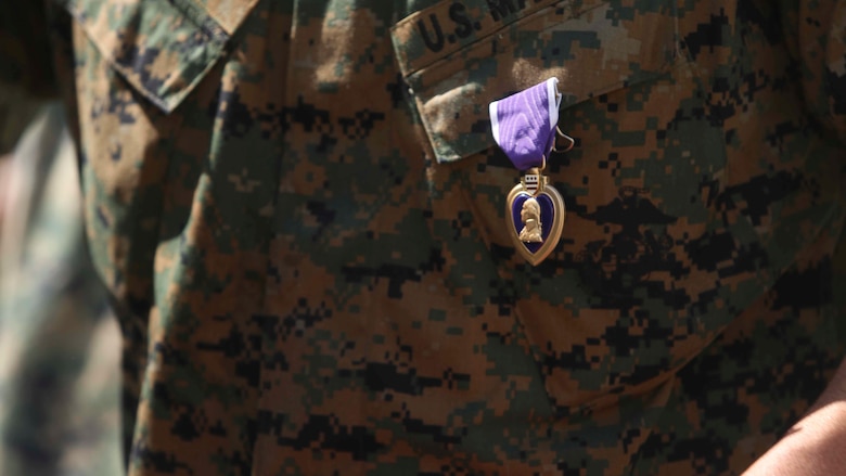 Lt. Col. Robert C. Sellers, 3rd Marine Expeditionary Brigade Assistant Chief of Staff G-4, receives a Purple Heart award during a ceremony in front of Secher Hall on Camp Hansen, Okinawa, Japan, October 28, 2016. The ceremony was held in front of Secher Hall to remind those in attendance to remember the fallen. 