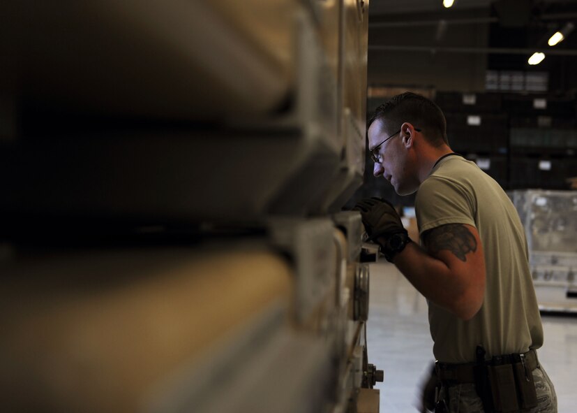 Staff Sgt. Joel Miller, 27th Special Operations Logistics Readiness Squadron Materiel Management flight Mobility Readiness Spare Package supervisor, assesses the position of a container during palletization at Cannon Air Force Base, N.M., October 19, 2016. MRSPs contain spare parts for aircraft and are used to support designated weapons systems for as many as 30 consecutive days downrange. Mere millimeters can determine whether a pallet is accepted or rejected for loading onto an aircraft prior to flight. (U.S. Air Force photo/Staff Sgt. Whitney Amstutz/released)