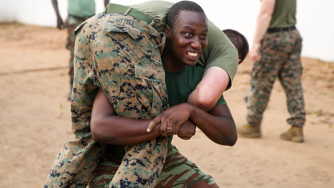 A sailor with the Benin Navy conducts buddy squats with 1st Lt. Joshua Littell, a team leader with Special Purpose Marine Air-Ground Task Force Crisis Response-Africa, during a physical fitness session at Benin Naval Forces Headquarters, Cotonou, Benin, October 25, 2016. The U.S. Marine Corps theater security cooperation team with SPMAGTF-CR-AF spent two weeks teaching an NCO development and maintenance management course during their time training with the Benin Navy.  