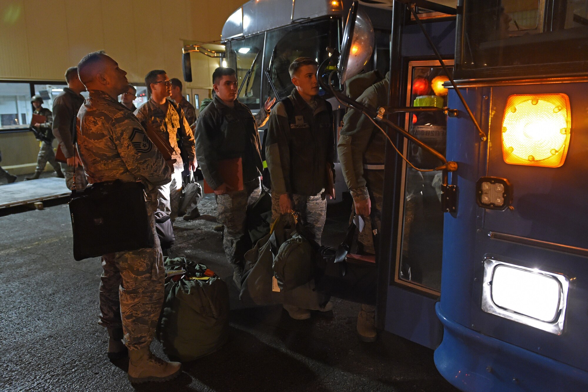 Joint Base Elmendorf-Richardson Airmen board buses as part of a mock-deployment during exercise Polar Force 17-1 at the Joint Mobility Center, Nov. 2, 2016. Regular operational exercises, like Polar Force 17-1, ensure maximum readiness to deploy across the installation. 