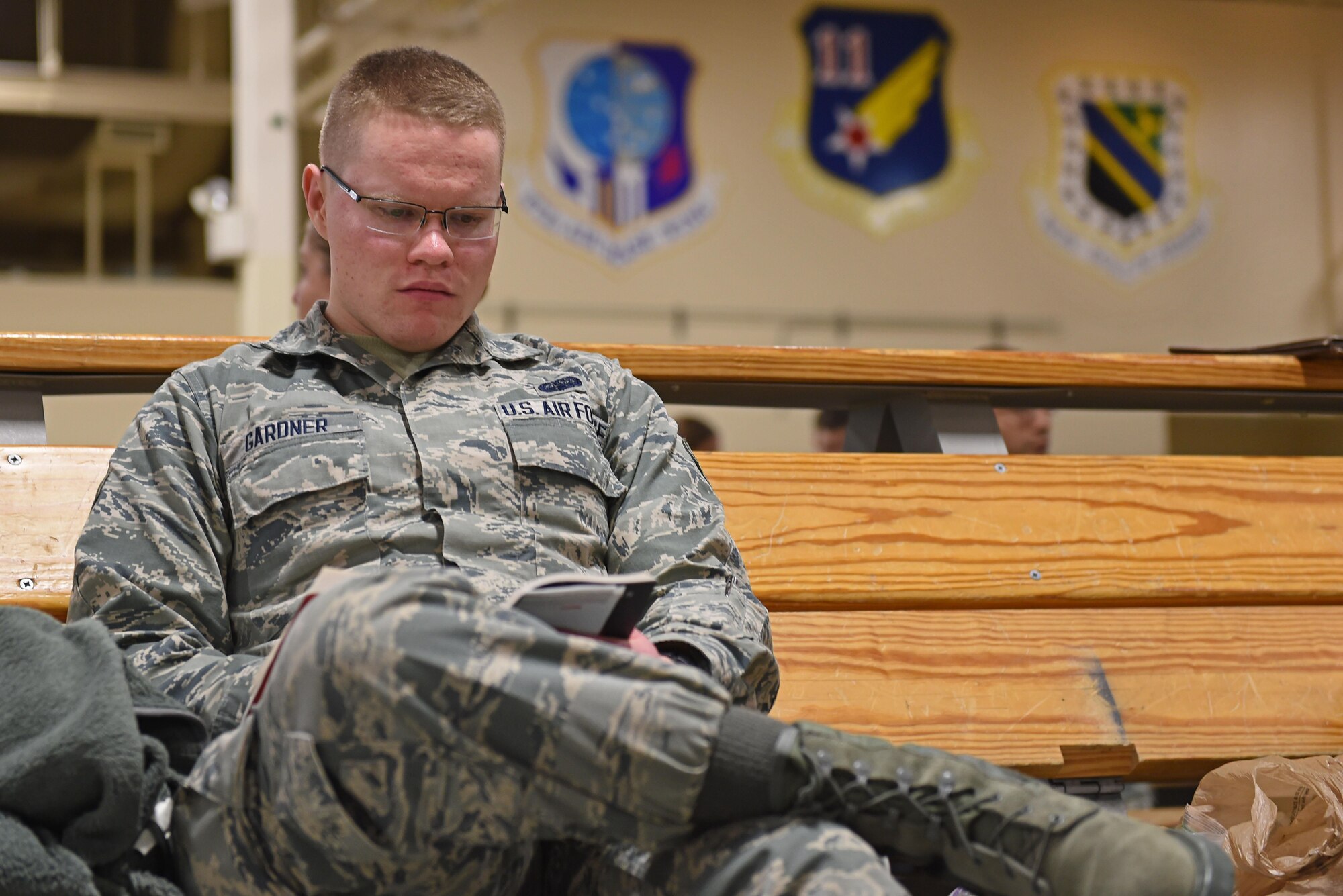 Joint Base Elmendorf-Richardson Airmen wait to participate in mock-deployment preparation during exercise Polar Force 17-1 at the Joint Mobility Center, Nov. 2, 2016. During the simulated exercise, Airmen moved through a process line to ensure their ability to deploy and were briefed by multiple agencies with vital information for their deployment. 