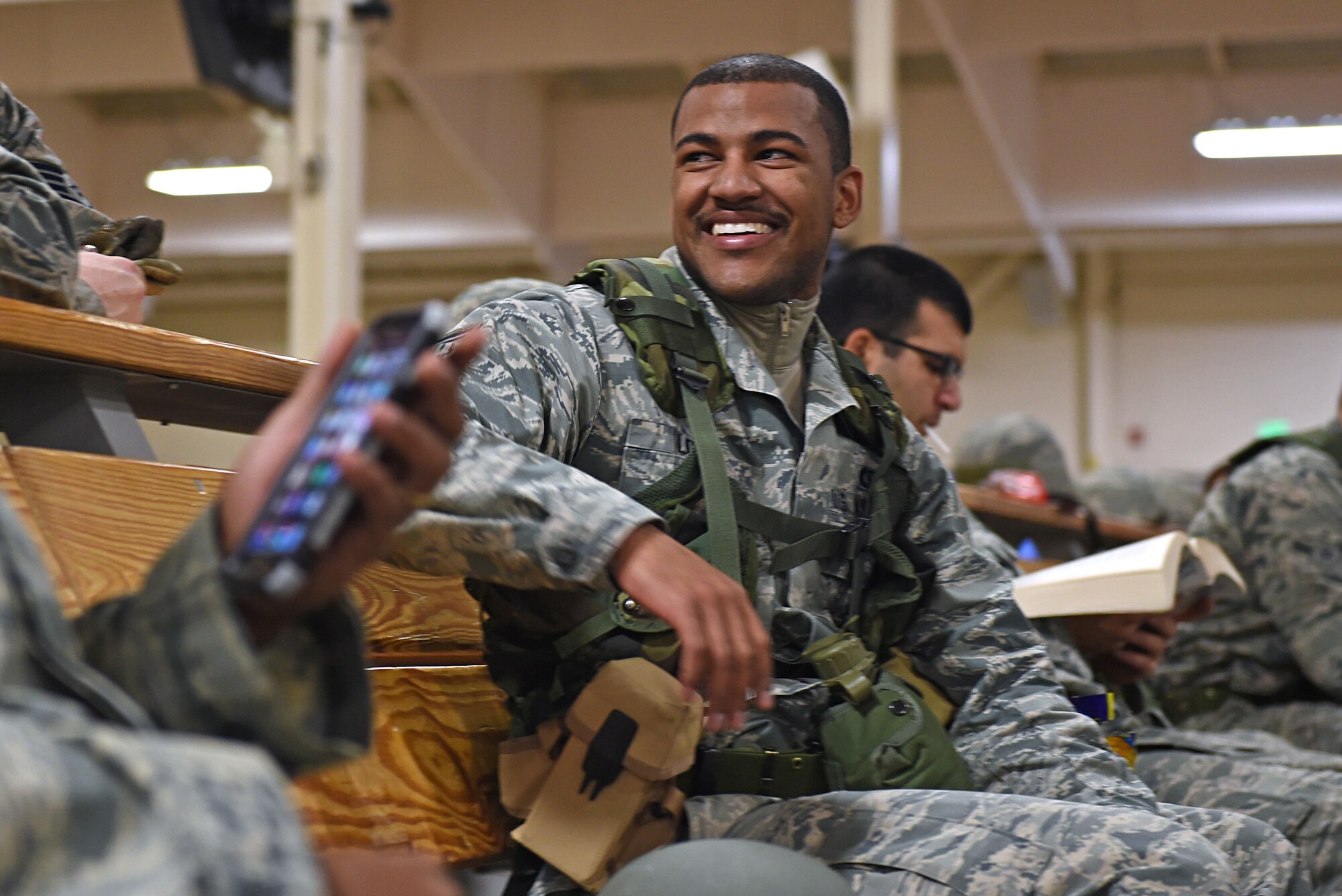 Senior Airman Quinton Lopez, 673d Civil Engineer Squadron engineer assistant, waits to take part in a simulated Personnel Deployment Function line before a mock-deployment as part of exercise Polar Force 17-1 at the Joint Mobility Center, Nov. 2, 2016. During the simulated exercise, Airmen moved through a process line to ensure their ability to deploy and were briefed by multiple agencies with vital information for their deployment. 