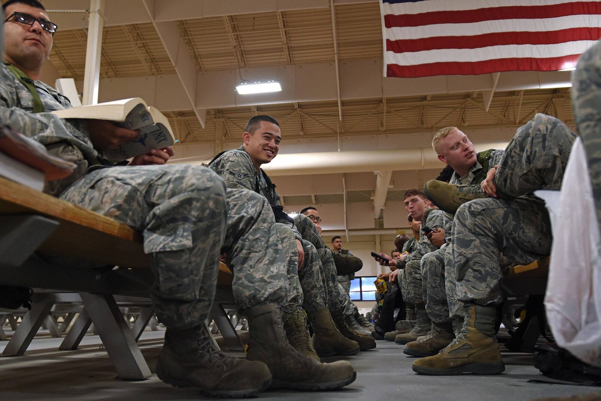 Joint Base Elmendorf-Richardson Airmen wait to participate in mock-deployment preparation during exercise Polar Force 17-1 at the Joint Mobility Center, Nov. 2, 2016. During the simulated exercise, Airmen moved through a process line to ensure their ability to deploy and were briefed by multiple agencies with vital information for their deployment. 