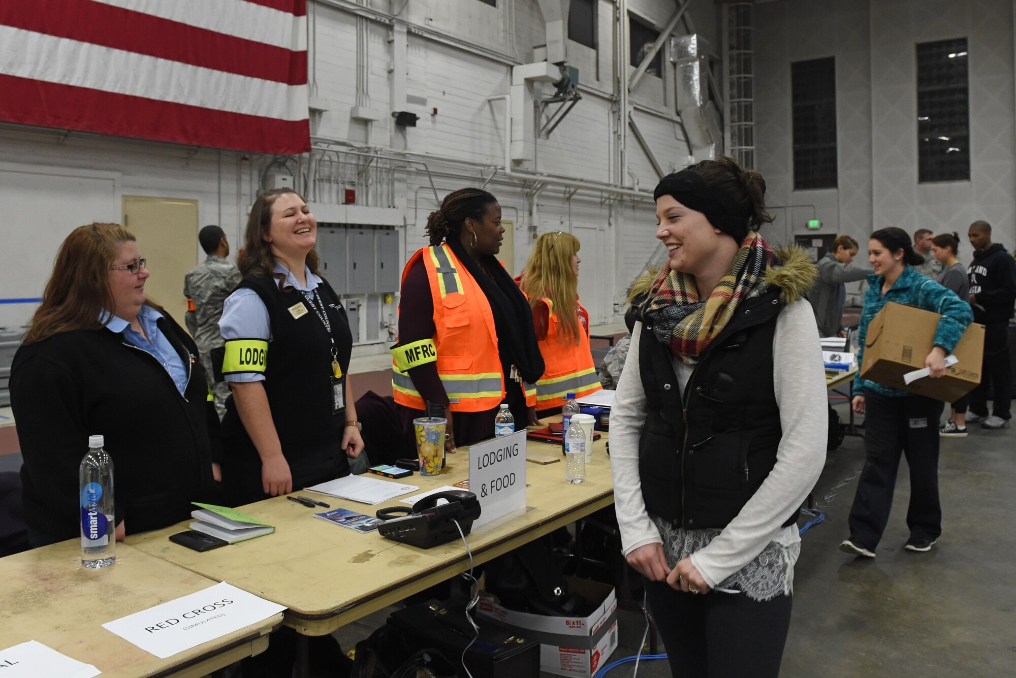 Participants of a noncombatant evacuation operation exercise walk through an in-processing line at Hangar 5, Joint Base Elmendorf-Richardson, Alaska, Nov. 3, 2016. The scenario was part of exercise Polar Force 17-1, which is designed to help validate and evaluate the wings' ability to integrate, mobilize, and prepare assigned personnel, aircraft and equipment for a wartime mission. 