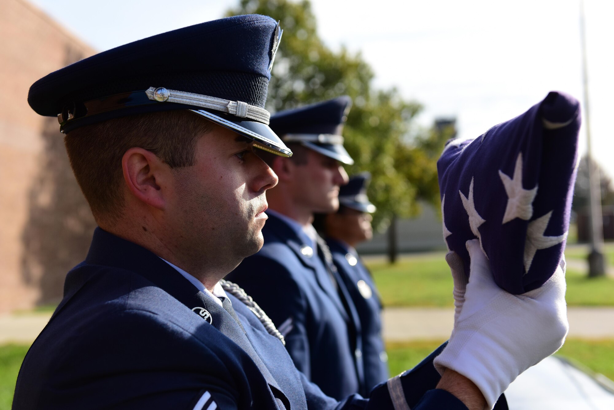 U.S. Air Force Senior Airman Jeffrey Pipkin, an A-team member of the Whiteman Air Force Base Honor Guard dresses a flag during a simulated funeral at Whiteman Air Force Base, Mo., Nov. 2, 2016. Made up of members from different units throughout the base, the Whiteman Honor Guard performs funeral and military honors in support of 99 counties in Missouri and 19 counties in Kansas, covering more than 70,000 square miles, one of the biggest areas of responsibility in all of Air Force Global Strike Command. (U.S. Air Force photo by Senior Airman Joel Pfiester)