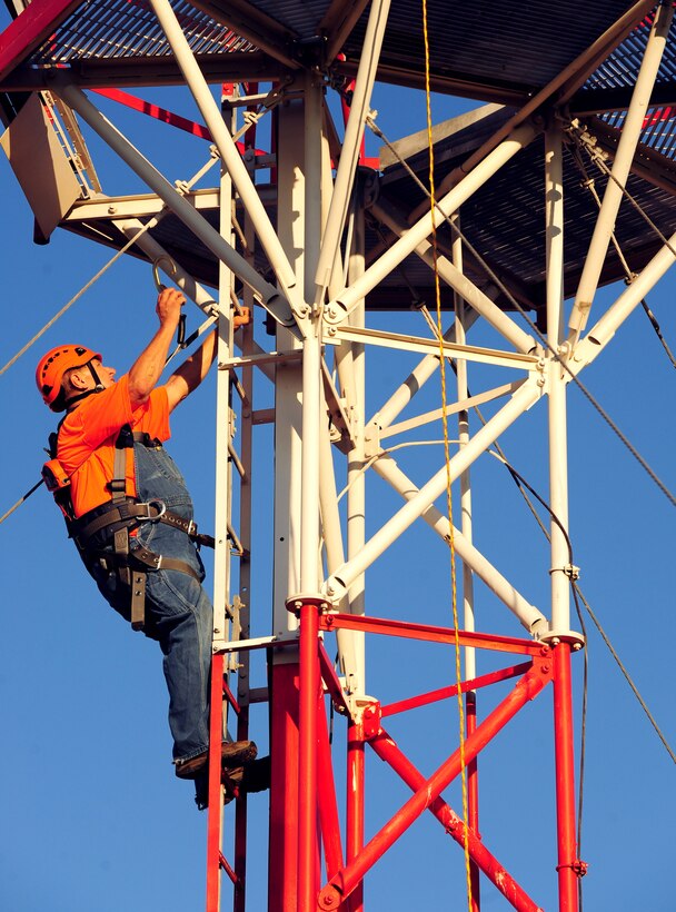 Steve Schroeder, Thales installer, climbs a ladder at Dyess Air Force Base, Texas, Oct. 18, 2016. Thales is one of the two companies that helped install the modernized Tactical Air Navigation system. (U.S. Air Force photo by Airman 1st Class April Lancto)