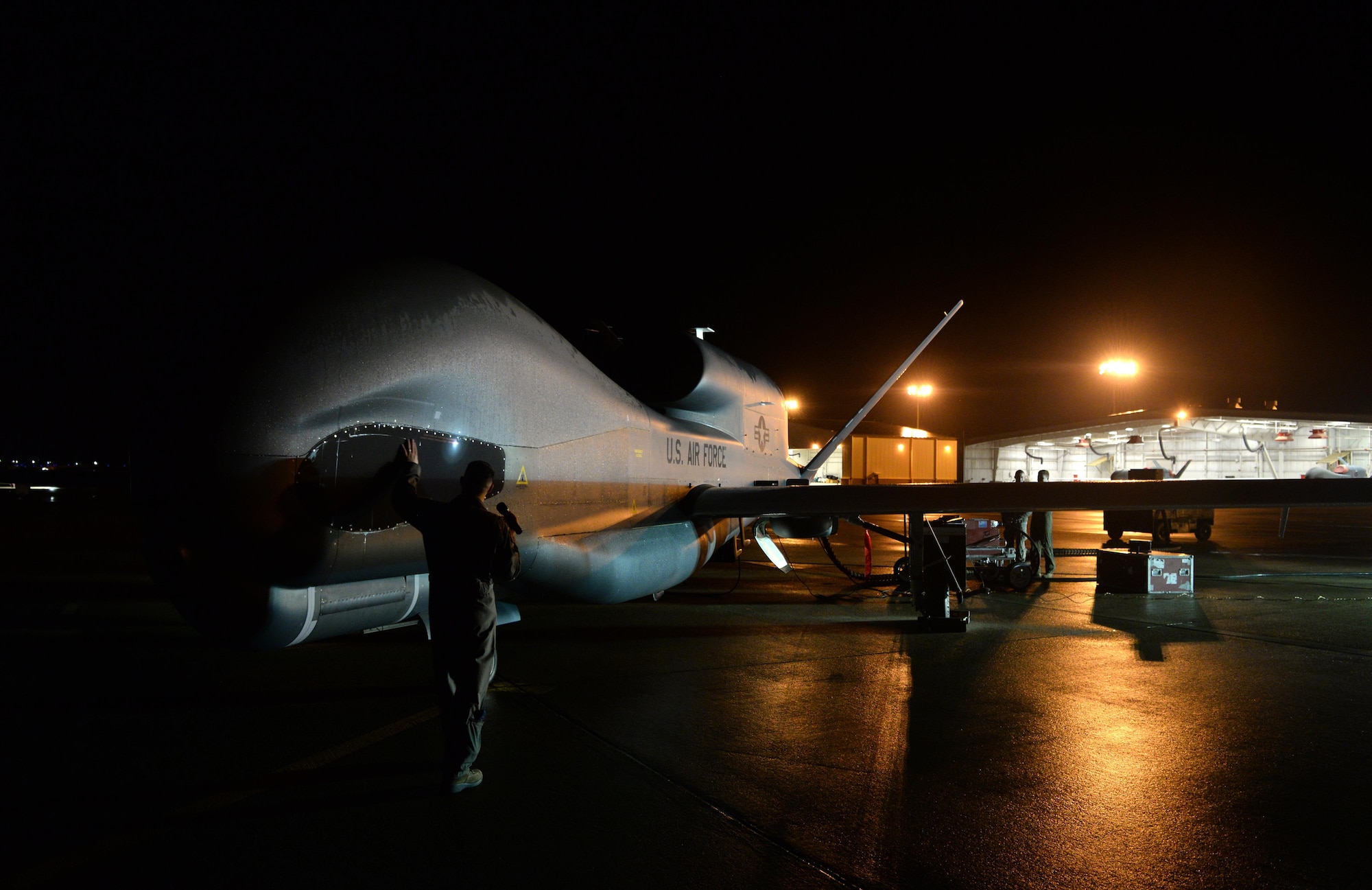 Capt. Thomas, 12th Reconnaissance Squadron RQ-4 Global Hawk pilot, conducts a walk around a RQ-4 Global Hawk prior to takeoff Nov. 1, 2016, at Beale Air Force Base, California. Thomas fulfilled the role of “Hawkeye”. Hawkeye is the call sign for the designated RQ-4 Pilot who performs pre-flight inspections before departure. (U.S. Air Force photo/Staff Sgt. Bobby Cummings)