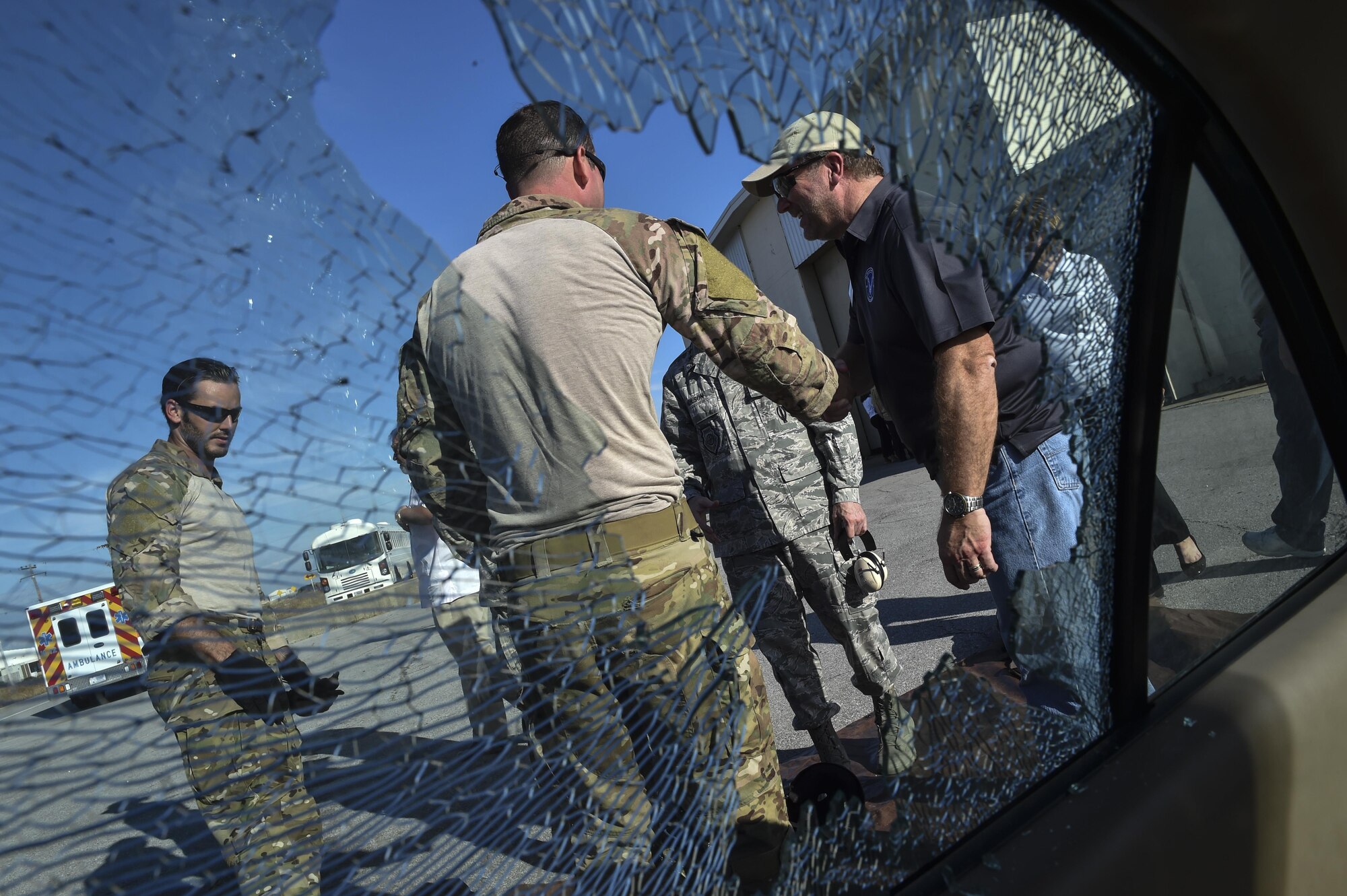 Special Tactics Airmen shake hands with civic leaders following a demonstration on breaking car windows during the Chief of Staff of the Air Force Civic Leader Tour at Hurlburt Field, Fla., Nov. 2, 2016. An ST pararescueman specializes in search and recovery dives, swift water rescue, confined space rescue, high-angle rescue and classified material recovery. 