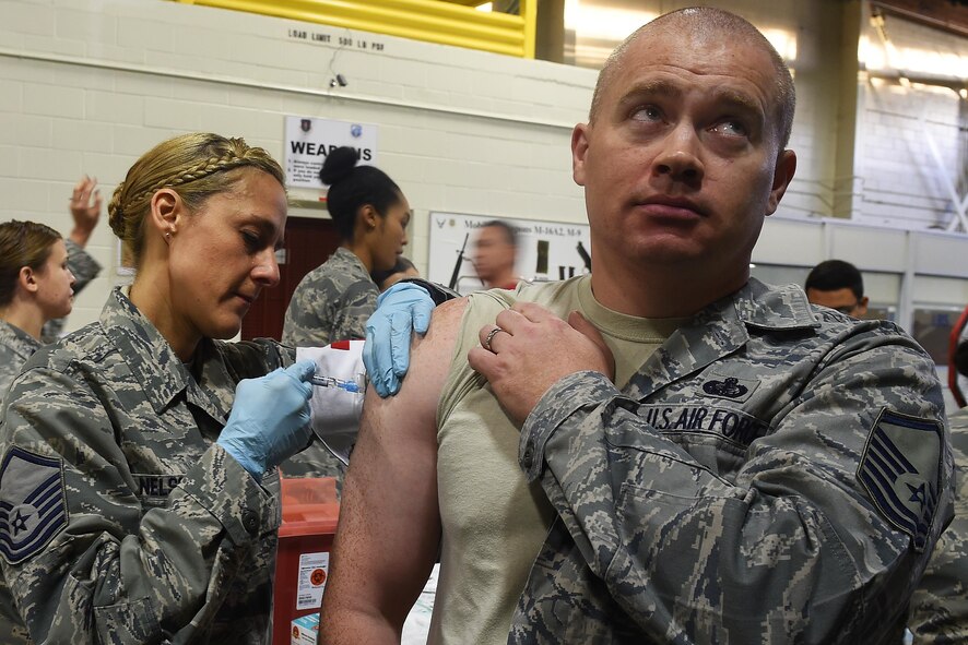 Master Sgt. Petra Nelson, 62nd Medical Squadron dental section chief, administers the flu vaccine to Team McChord Airmen Oct. 28, 2016, during a point of dispensing exercise at Joint Base Lewis-McChord, Wash. The exercise aimed to test McChord Field’s ability to vaccinate the base populace in the event of a harmful disease outbreak. (U.S. Air Force photo\ Tech. Sgt. Tim Chacon)