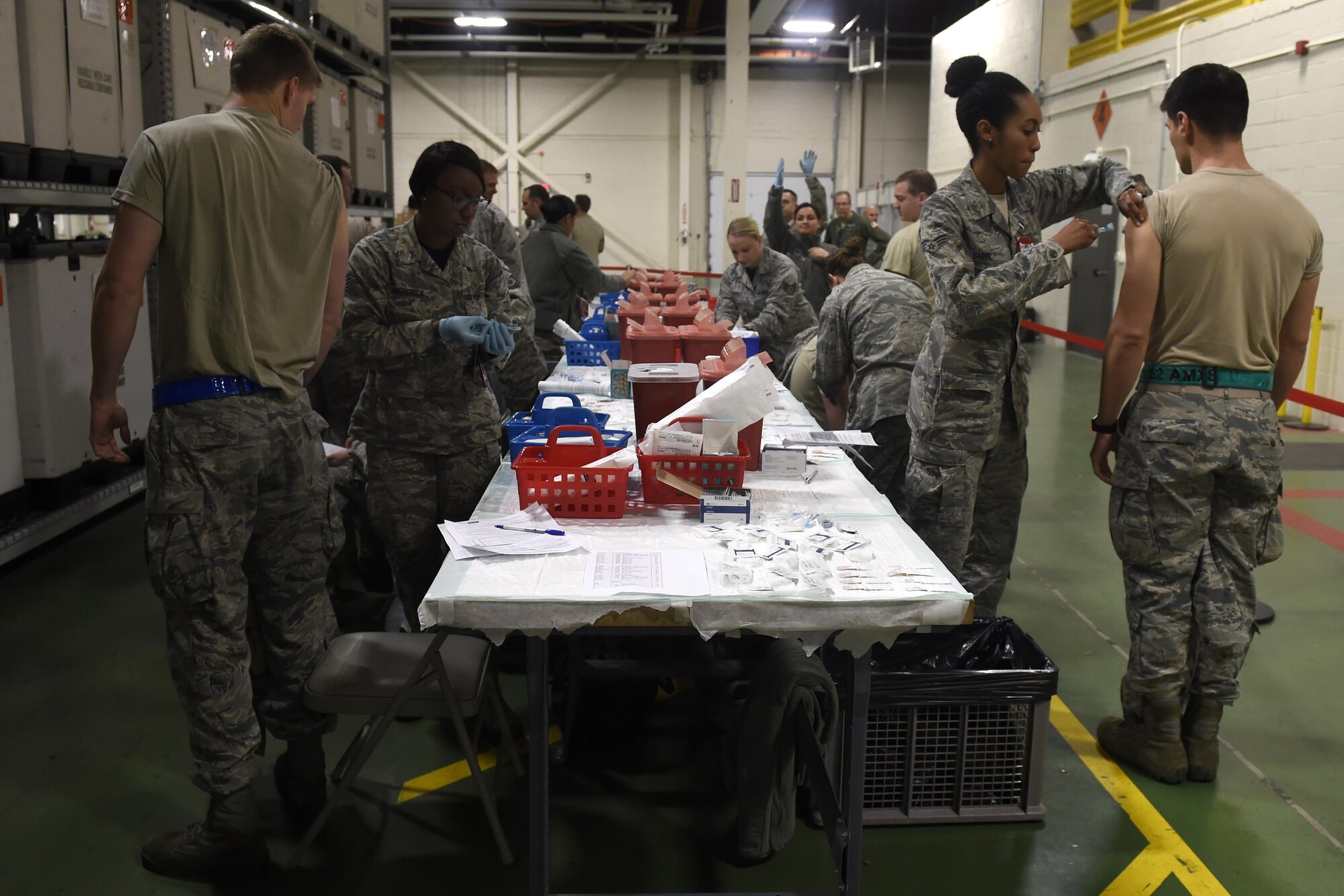 Airmen from the 62nd Medical Squadron administer annual flu vaccines Oct. 28, 2016, at Joint Base Lewis-McChord, Wash. The vaccines were administered as part of a point of dispensing exercise. (U.S. Air Force photo\ Tech. Sgt. Tim Chacon)