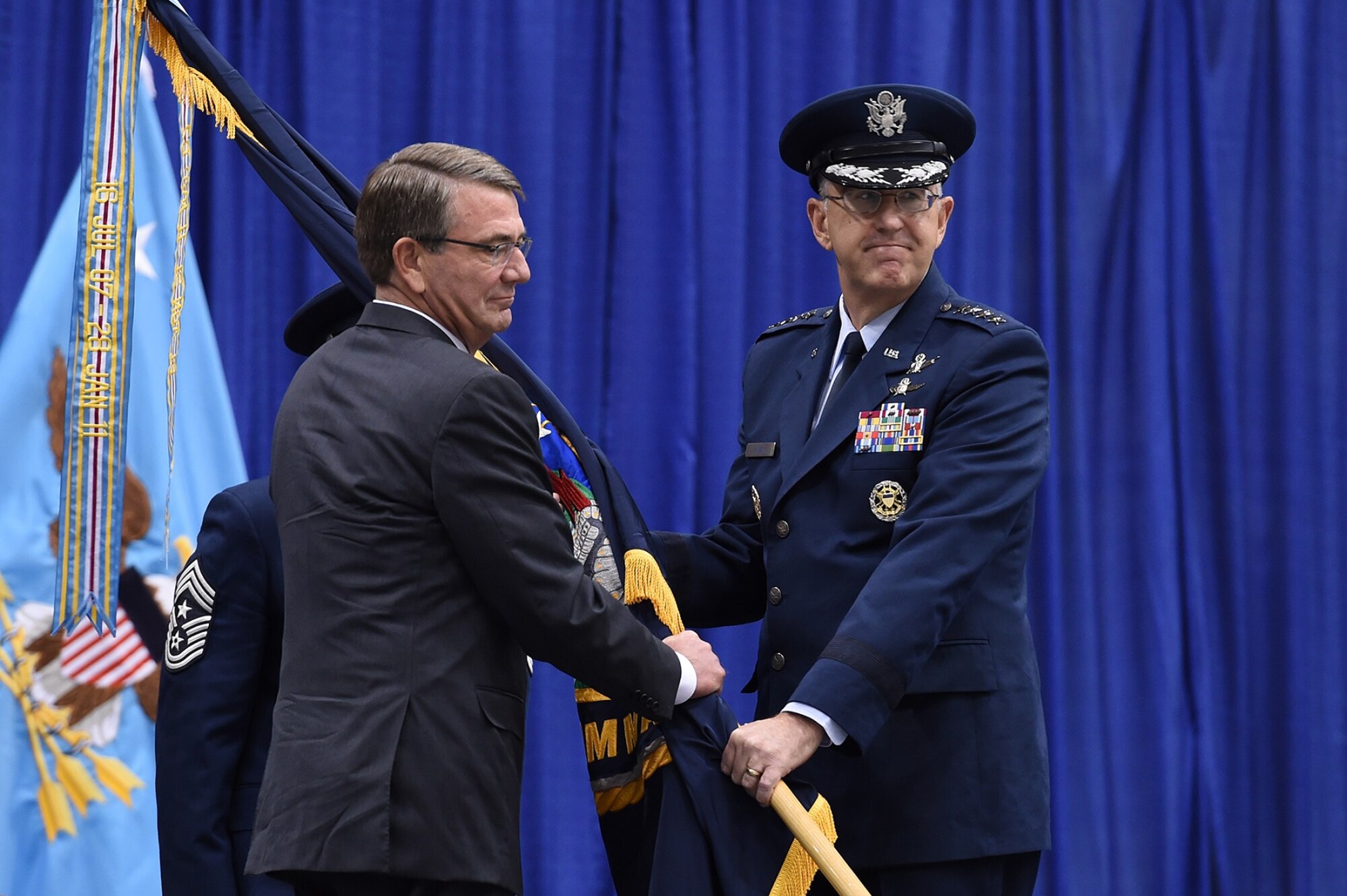 Gen. John E. Hyten (right), accepts the command guidon from Secretary of Defense Ash Carter as he assumes command of U.S. Strategic Command (USSTRATCOM) during a change of command ceremony at Offutt Air Force Base, Neb., Nov. 3, 2016. Carter presided over the change of command and provided remarks during which he congratulated Hyten on his appointment as the new USSTRATCOM commander. He also thanked Adm. Cecil D. Haney, outgoing USSTRATCOM commander, for his service. Additionally, Chairman of the Joint Chiefs of Staff Gen. Joseph F. Dunford provided remarks during the ceremony and presented the Joint Meritorious Unit Award to USSTRATCOM. Hyten previously served as commander of Air Force Space Command, and Haney will retire from active military duty during a separate ceremony in January. One of nine DoD unified combatant commands, USSTRATCOM has global strategic missions assigned through the Unified Command Plan that include strategic deterrence; space operations; cyberspace operations; joint electronic warfare; global strike; missile defense; intelligence, surveillance and reconnaissance; combating weapons of mass destruction; and analysis and targeting. (U.S. Air Force photo by Staff Sgt. Jonathan Lovelady)