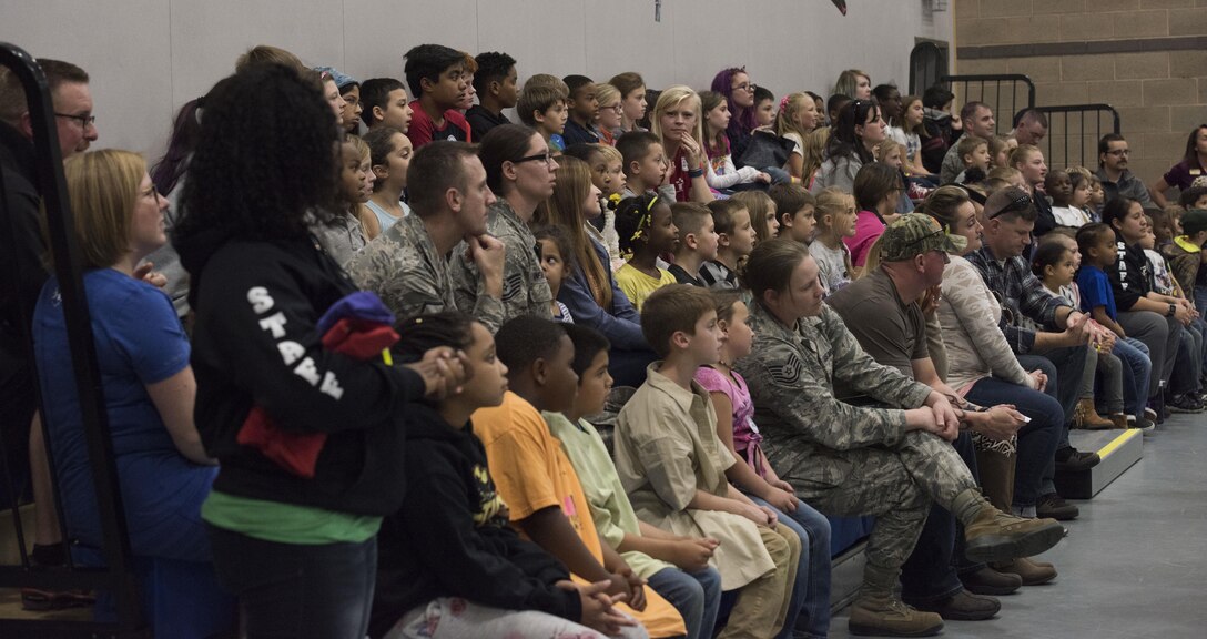 The audience watches a video at the Lights on After School open house event, October 26, 2016 at Mountain Home Air Force Base, Idaho. The video displayed various activities the children typically participate in after school. (U.S. Air Force photo by Airman 1st Class Alaysia Berry/Released)