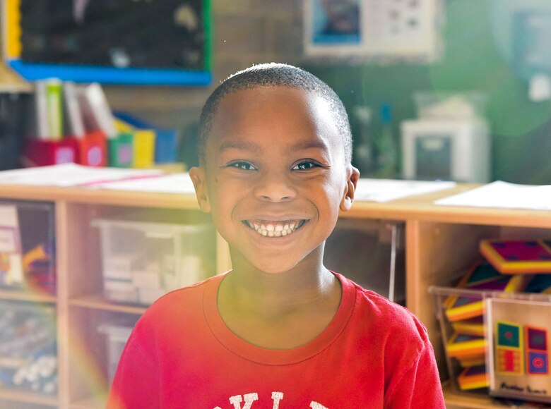 A student smiles at the camera during the Lights on After School open house event, October 26, 2016 at Mountain Home Air Force Base, Idaho. Lights on Afterschool is a project dedicated to ensuring that all children have access to quality programs.(U.S. Air Force photo by Airman 1st Class Alaysia Berry/Released)