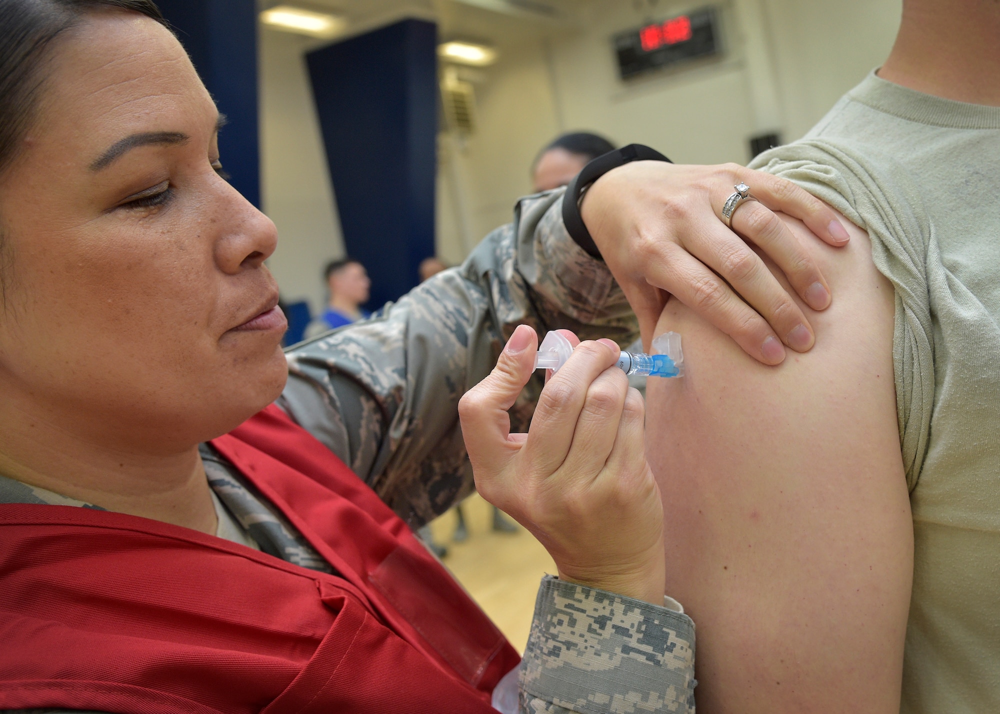 U.S. Air Force Senior Master Sgt. Chi Swanson, the 35th Medical Operations Squadron superintendent, administers a flu vaccine during a point of distribution, at Misawa Air Base, Japan, Nov. 3, 2016. The flu POD showcased the 35th Medical Group’s capability to immunize a large amount of people quickly and to learn their roles during a real-world epidemic. (U.S. Air Force photo by Senior Airman Deana Heitzman)