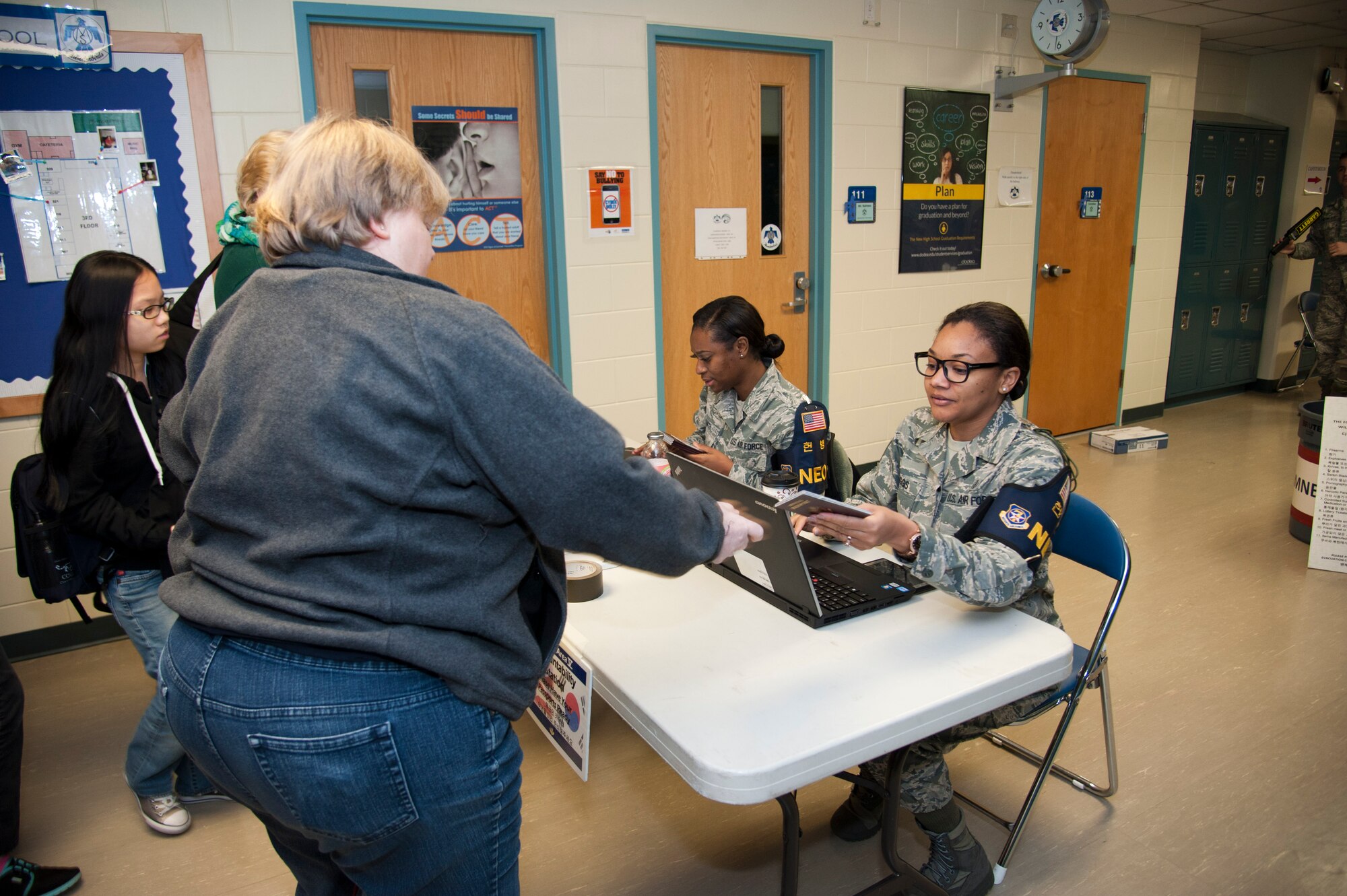 U.S. Air Force Staff Sgt. Chakara Canty, right, 25th Fighter Squadron NCO in charge of information management, and Tech. Sgt. Lashawnda Biggs, 51st Medical Support Squadron NCO in charge of Tricare operations, check in evacuating non-combatants during exercise Courageous Channel 2016 at Osan Air Base, Republic of Korea, Oct. 29, 2016. The exercise tested the non-combatant evacuation operational assembly line with families stationed on Osan and the surrounding areas. (U.S. Air Force photo by Staff Sgt. Jonathan Steffen)