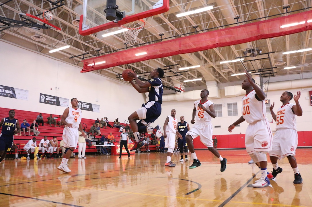 Navy’s Ensign Tilman Dunbar of the USS Bataan hits the reverse lay-up and led the board with 16 points and five assists as Navy topped Marine Corps 73-58.  The 2016 Armed Forces Men's Basketball Championship held at MCB Quantico, Va. from 1-7 November.  The best two teams during the doubel round robin will face each other for the 2016 Armed Forces crown.  