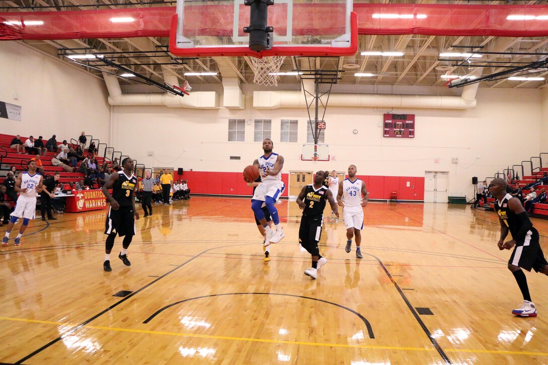 Air Force Senior Airman Daveon Allen has a free lane to the net scoring 18 points against Army. Army won the game in double overtme wtih a score of 91-88.  The 2016 Armed Forces Men's Basketball Championship held at MCB Quantico, Va. from 1-7 November.  The best two teams during the doubel round robin will face each other for the 2016 Armed Forces crown.  