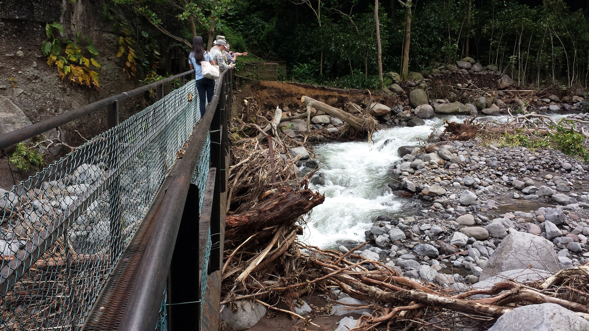 Maui island based Hawaii National Guard Airmen and Soldiers along with Maui civilian officials survey debris in the Wailuku river September 2016. Storm generated heavy rains on Sep. 13th caused river swelling and flash flooding impacting area residents and damaging property and infrastructure. The service members volunteered for state active duty from Sep. 21 to Sep. 27 for domestic operations to provide humanitarian asistance. (courtesy photo)