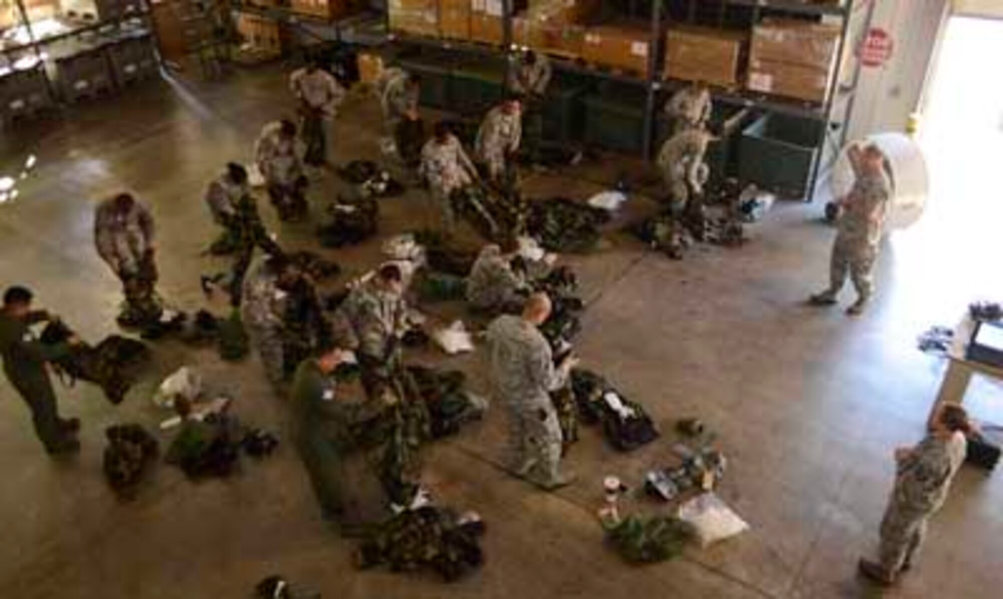 Airmen from the 189th Airlift Wing prepare to don mission oriented protective posture gear during a chemical, biological, radiological or nuclear training scenario Oct. 6, 2016, at Little Rock Air Force Base. The training is provided to all Airmen, regardless of rank and orients them with the potentially life-saving equipment. (U.S. Air National Guard photo by Tech. Sgt. Jessica Condit) 