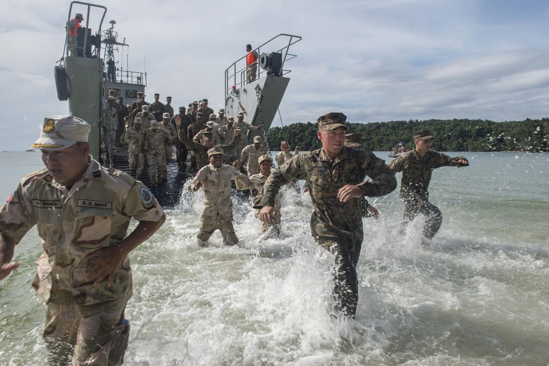 U.S. Marines and sailors and Cambodian sailors disembark a Cambodian amphibious landing craft during Cooperation Afloat Readiness and Training Cambodia 2016 in Sihanoukville, Cambodia, Nov. 3, 2016. The Marines are assigned to 3rd Battalion, 2nd Marine Regiment, and the Seabees are assigned to Naval Mobile Construction Battalion 5. The annual maritime training involves U.S troops and armed forces from nine partner nations, including Bangladesh, Brunei, Cambodia, Indonesia, Malaysia, the Philippines, Singapore, Thailand and Timor-Leste. Navy photo by Chief Petty Officer Lowell Whitman