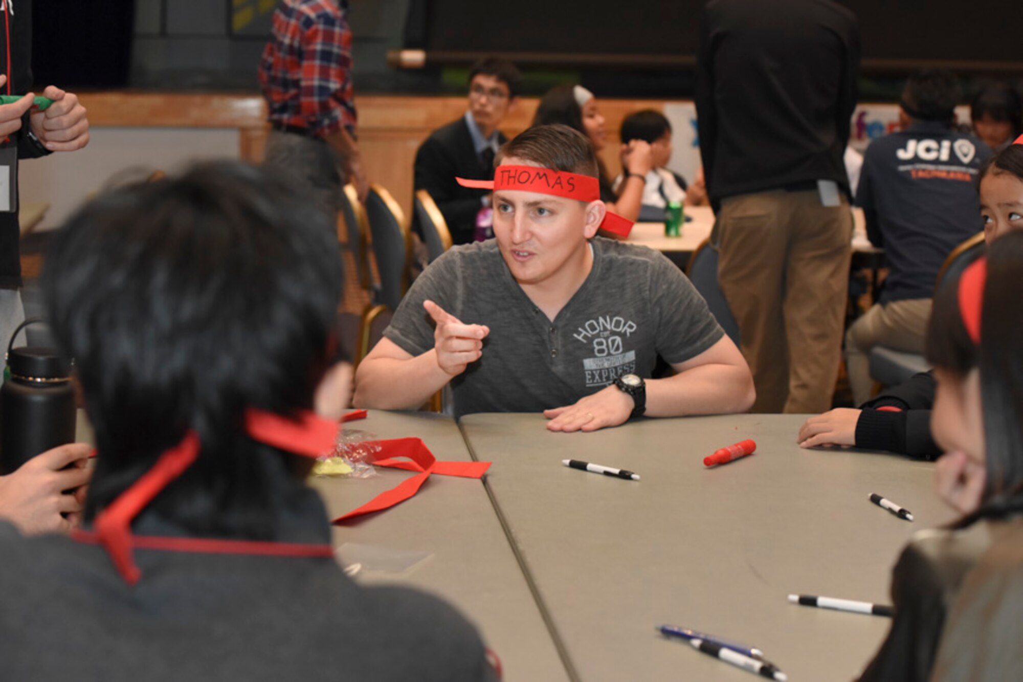 1st Lt. Daryl Thomas, 730th Air Mobility Squadron executive officer, introduces himself during the Youth International Exchange Fair at Yokota Air Base, Japan, Oct. 29, 2016. The fair hosted by the Yokota Company Grade Officers Council and Junior Chamber International Japan to foster interaction between Japanese and Yokota children. (U.S. Air Force photo by Machiko Arita/Released)