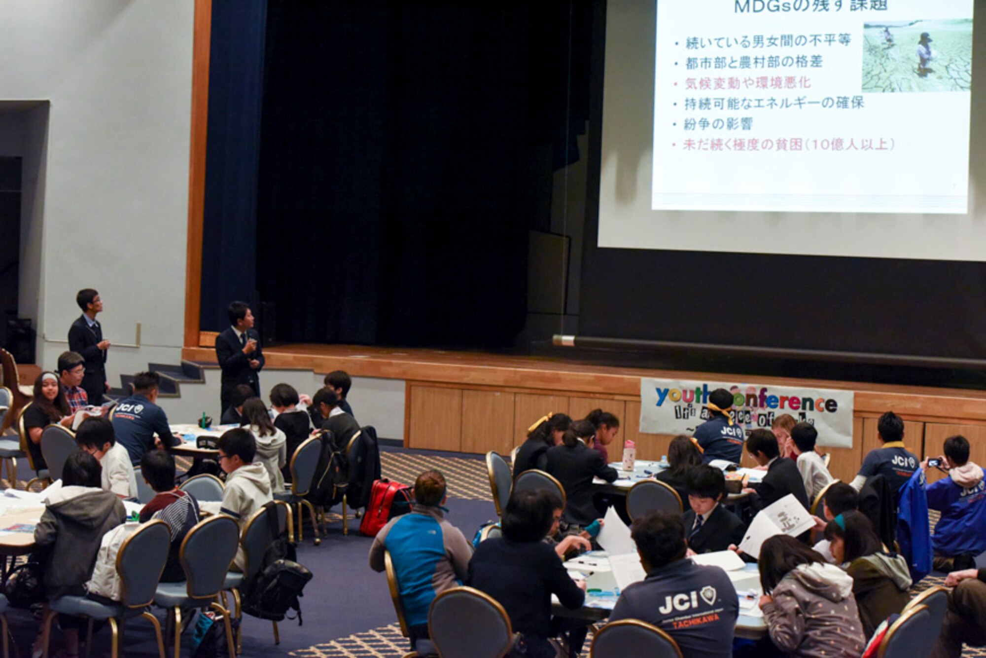 Members with the Junior Chamber International Japan gives a presentation during the Youth international Exchange Fair at Yokota Air Base, Japan, Oct. 29, 2016. The fair hosted by the Yokota Company Grade Officers Council and JCI to foster interaction between Japanese and Yokota children. Japanese and American student discussed the United Nations 2030 Global Goals during a workshop. (U.S. Air Force photo by Machiko Arita/Released)