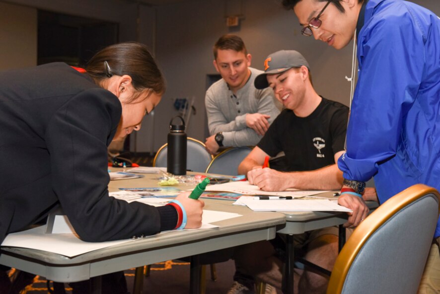 A workshop team prepares for a presentation during the Youth international Exchange Fair at Yokota Air Base, Japan, Oct. 29, 2016. The fair hosted by the Yokota Company Grade Officers Council and Junior Chamber International Japan to foster interaction between Japanese and Yokota children. Japanese and American student discussed the United Nations 2030 Global Goals during a workshop. (U.S. Air Force photo by Machiko Arita/Released)