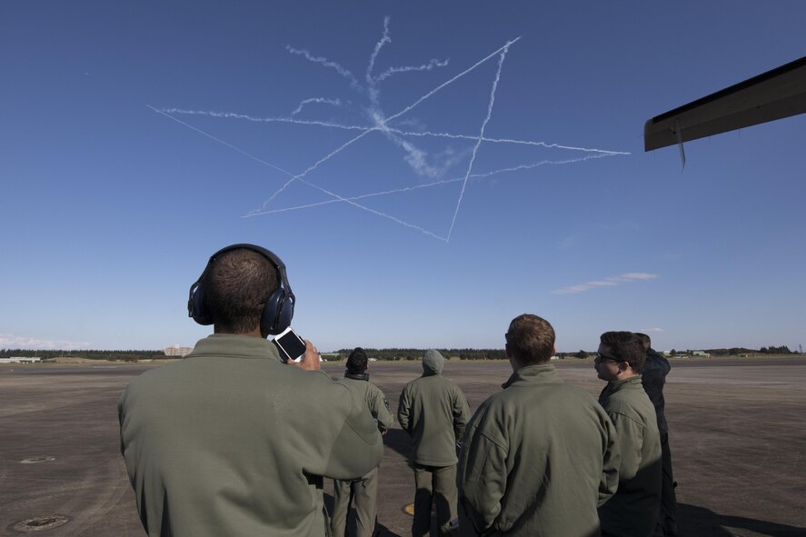 U.S. Air Force members with the 459th Airlift Squadron watch the Japan Air Self-Defense Force aerobatic team, Blue Impulse, demonstration during an annual air show at Iruma Air Base, Japan, Nov. 3, 2016. More than 130,000 people of all ages attended the show. A UH-1N Iroquois and a C-12 Huron assigned to the 459 AS participated in the static display. (U.S. Air Force photo by Yasuo Osakabe/Released)  