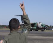 U.S. Air Force Capt. Vicente Vasquez, 459th Airlift Squadron UH-1N Iroquois pilot, cheers Japan Air Self-Defense Force C-1 crewmembers during an annual air show at Iruma Air Base, Japan, Nov. 3, 2016. More than 130,000 people of all ages attended the show. The Japan Self-Defense Forces showed off a wide range of its finest airplanes including the Blue Impulse JASDF aerobatic demonstration team. Also, a UH-1N and a C-12 Huron assigned to the 459 AS participated in the static display. (U.S. Air Force photo by Yasuo Osakabe/Released)     