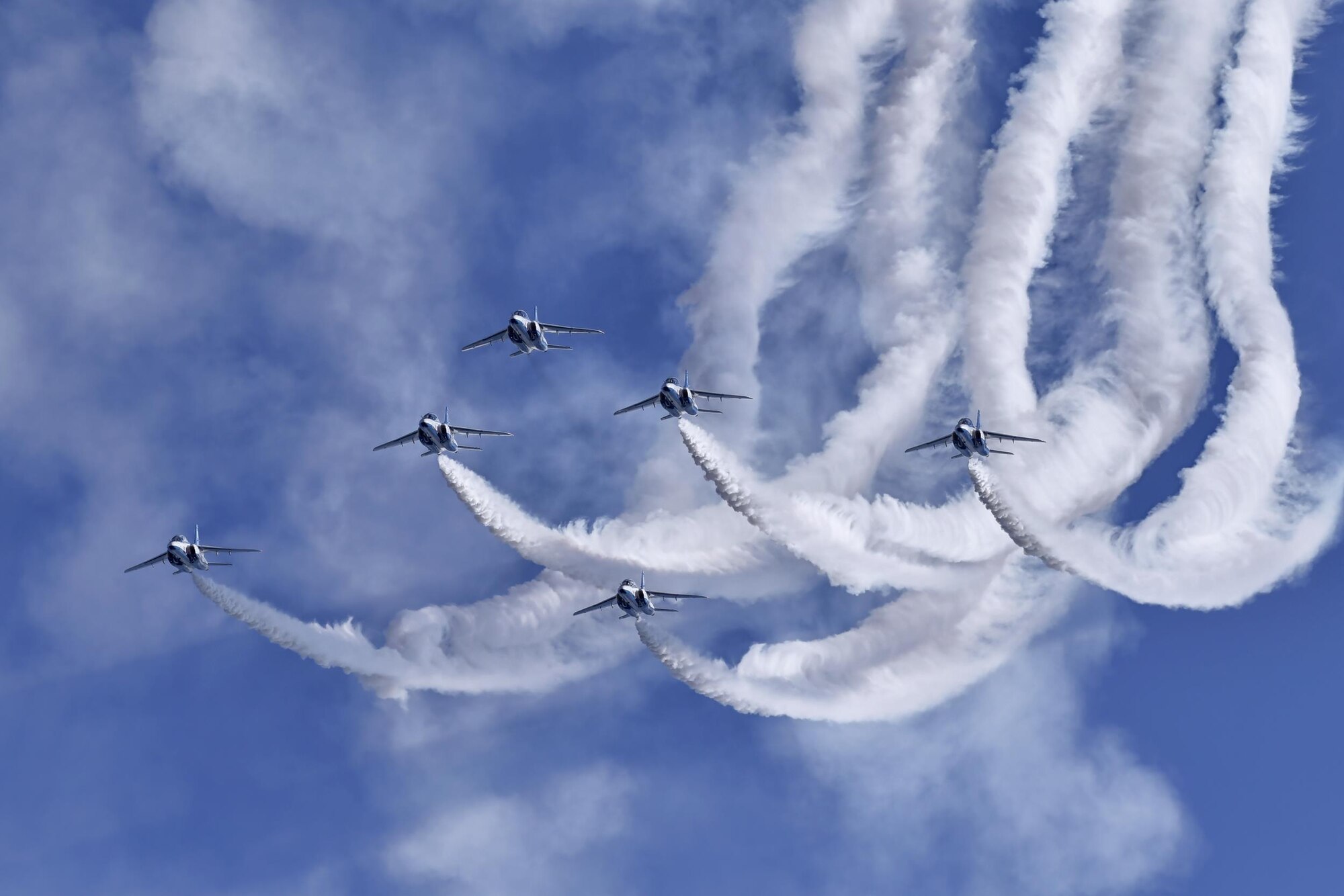 The Japan Air Self-Defense Force aerobatic team, Blue Impulse, fly in formation over Iruma Air Base, Japan, Nov. 3, 2016. Blue Impulse used the smoke-trails to sketch artistic patterns in the sky. (U.S. Air Force photo by Senior Airman Delano Scott/Released)