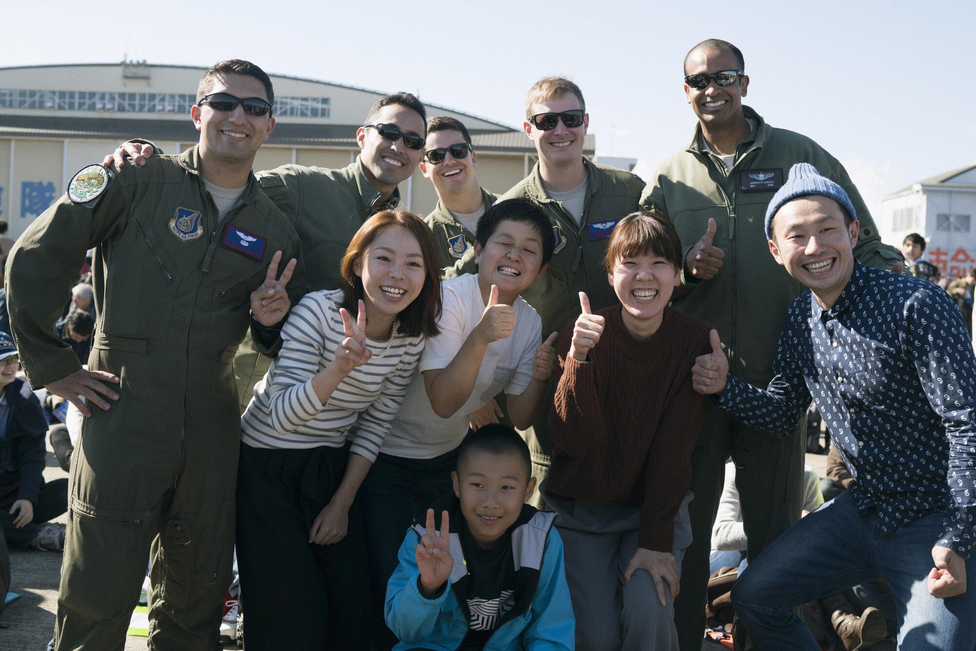 Members of the 459th Airlift Squadron and festivalgoers pose for a photo at Iruma Air Base, Japan, Nov. 3, 2016. The 459th Airlift Squadron’s participation in the annual air show allowed Yokota Airmen an opportunity to build relationships with their Japan Air Self-Defense Force partners and interact with the members of the local community. (U.S. Air Force photo by Airman 1st Class Delano Scott/Released)