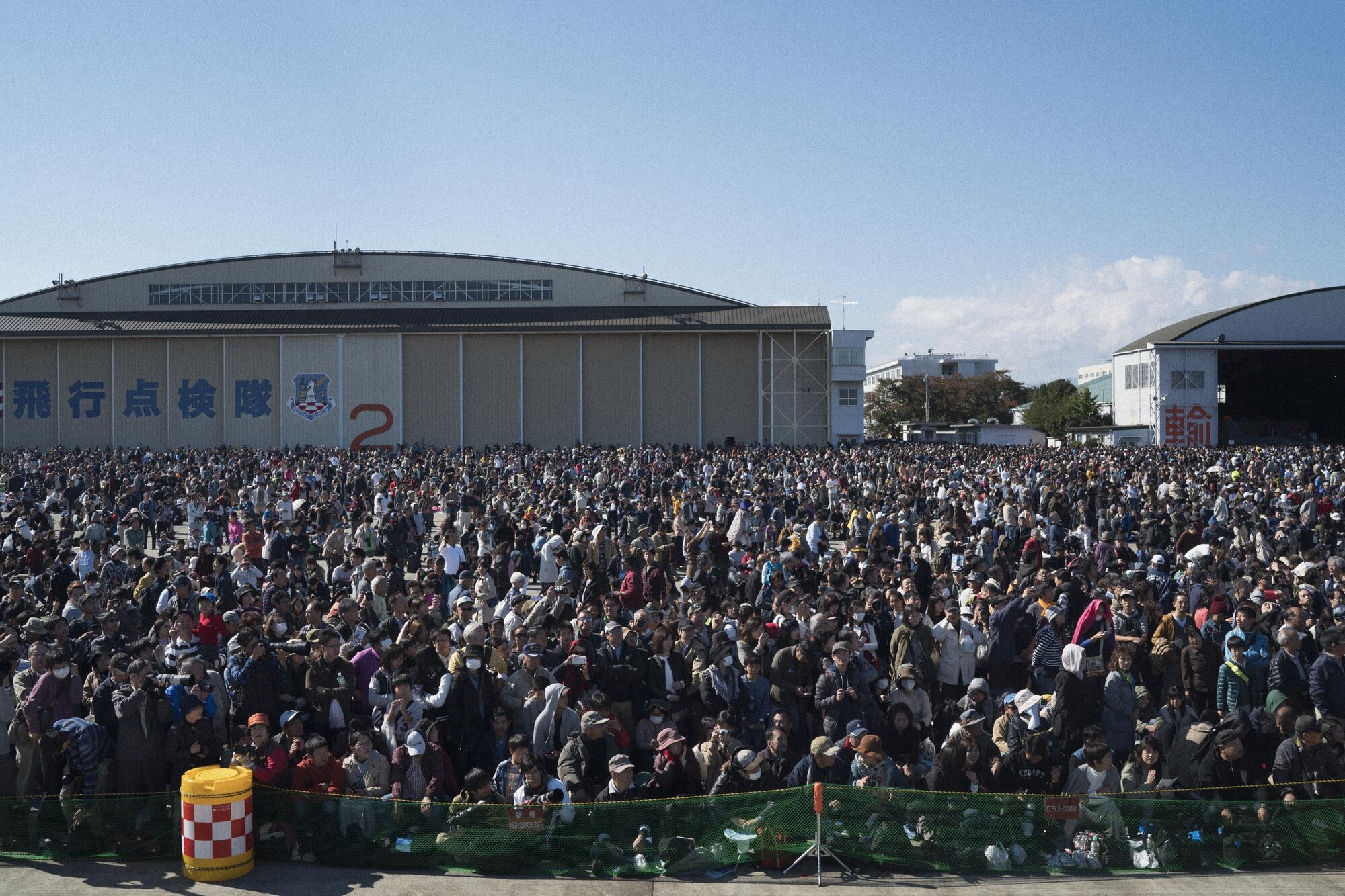 A crowd watches a flight demonstration at the annual air show at Iruma Air Base, Japan, Nov. 3, 2016. Members of the 459th AS participated in the annual Iruma Air Show, a Japan Air-Self-Defense Force hosted event in a neighboring prefecture. (U.S. Air Force photo by Senior Airman Delano Scott/Released)